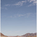 Vast Desert Road Under A Clear Blue Sky